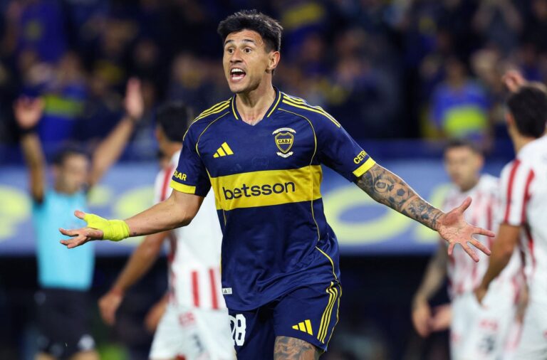 Jugadores de Talleres y Boca Juniors en acción durante un partido de fútbol en el estadio Mario Alberto Kempes.