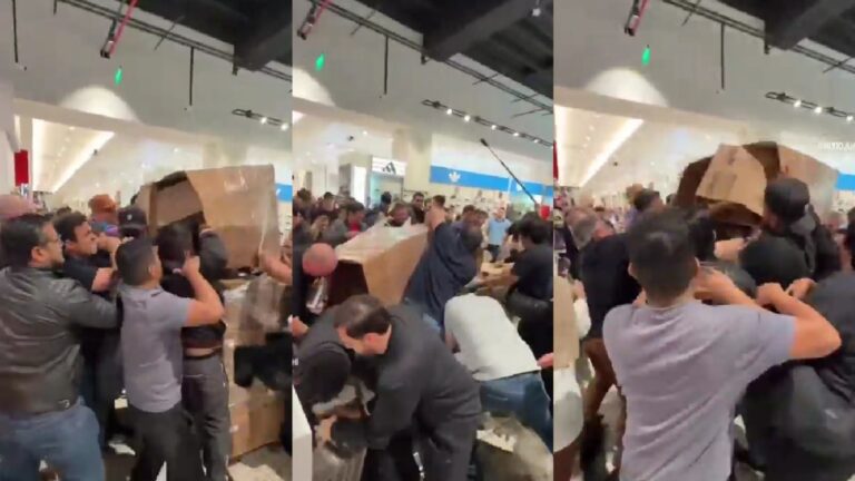 Multitud corriendo hacia pallets de cajas de iPhone 17 en un shopping de Ciudad del Este