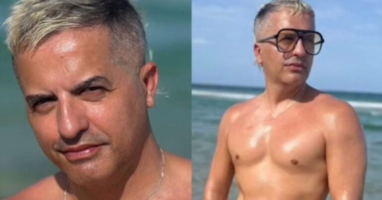 Ángel De Brito en la playa de Miami con torso desnudo y lentes de sol