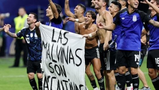 Bandera argentina con la inscripción Las Malvinas son argentinas exhibida por la Selección